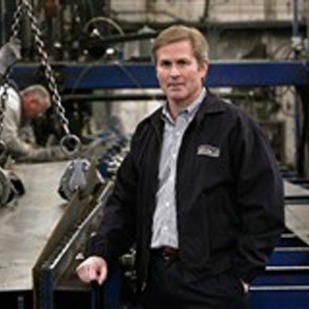 A Man Wearing Black Jacket; metal building manufacturer
