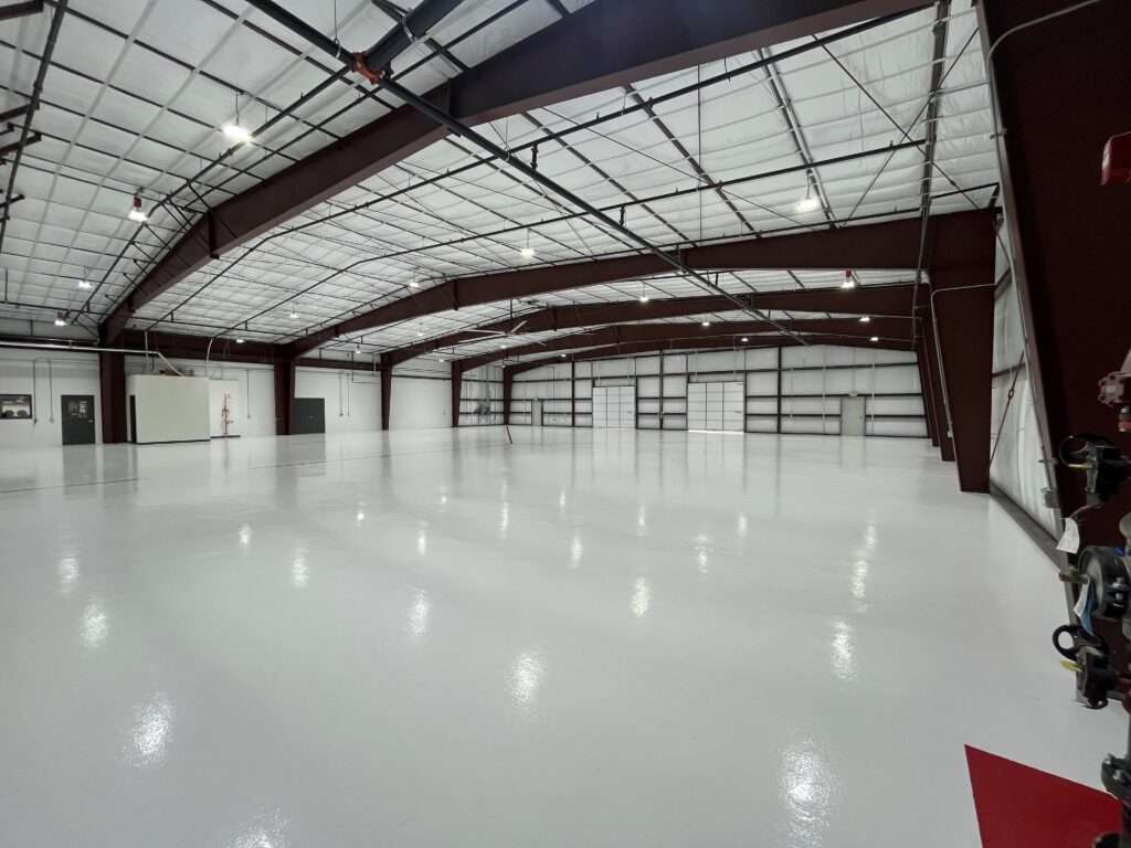 Metal building interior with liner insulation, sprinkler system, and epoxy floor